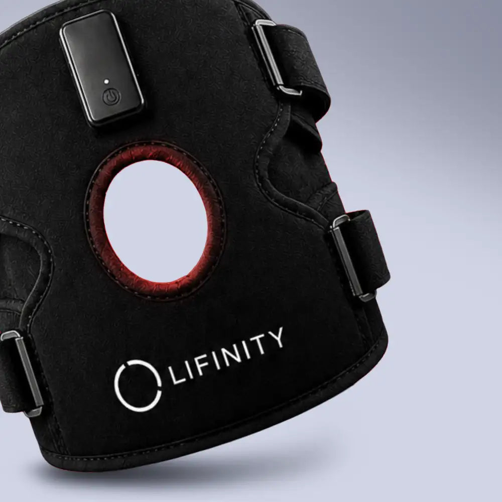 A close-up of a black LIFINITY support brace with adjustable straps, a circular cutout showing a red inner lining, and a small rectangular electronic control unit attached near the top.
