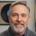 Man with a beard and gray hair smiling